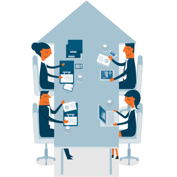 Image of four people sitting and working at a table that is shaped as an arrow.