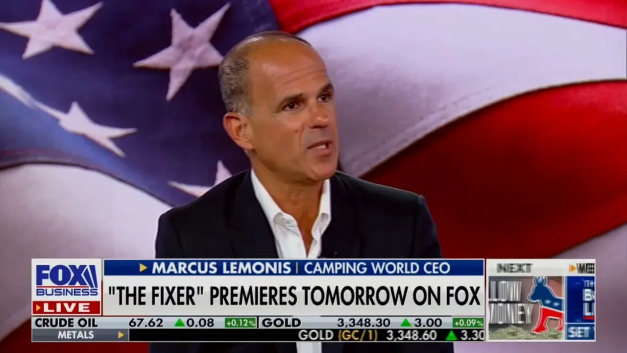 A man in a suit speaks during a Fox Business interview, with an American flag background. On-screen text promotes The Fixer premiering tomorrow on FOX.