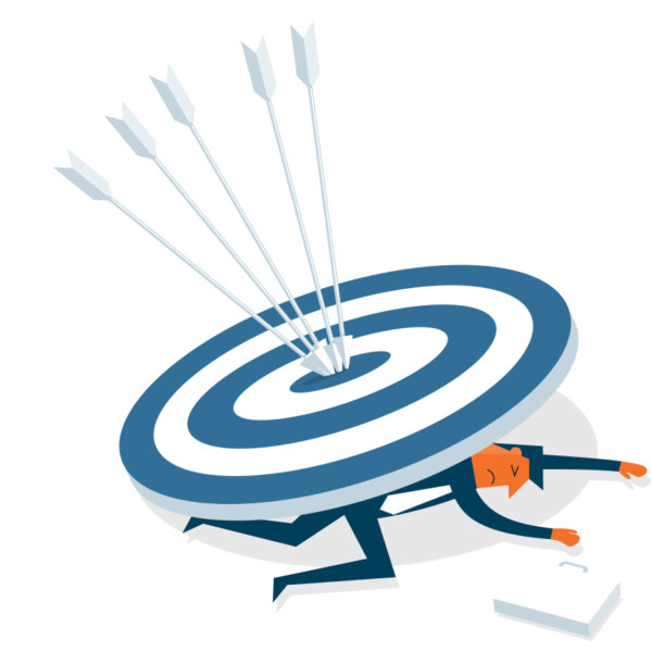 Image of someone underneath a large target with arrows in it.