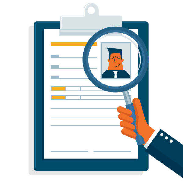 Image of a magnifying glass over a clipboard with a photo on it.