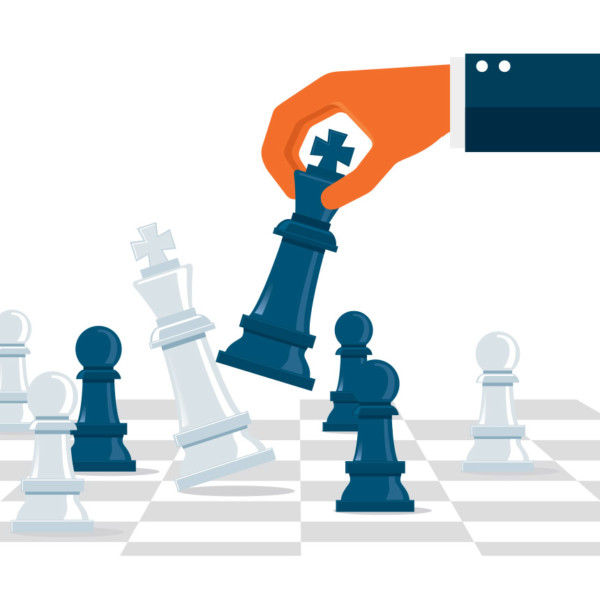 Image of a hand moving chess pieces.